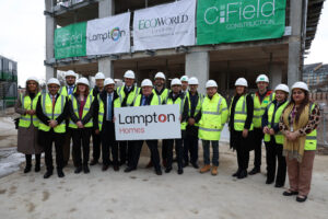 Golden Brick, London Borough of Hounslow Councillors and Lampton Staff holding a sign to celebrate 
