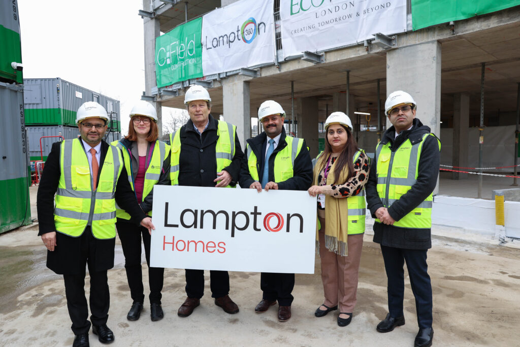 Golden Brick, London Borough of Hounslow Councillors and Lampton Staff holding a sign to celebrate